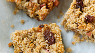 Three squares of oat mixture with apple, apricot and sultanas in