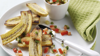 Grilled plantains, served with a salsa made of finely chopped tomatoes, cucumber and spring onions.