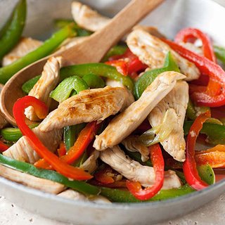 Sliced turkey, green and red pepper stir-fry