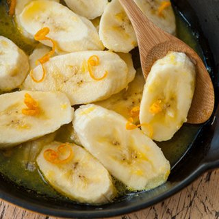 Sliced bananas with orange zest and yoghurt