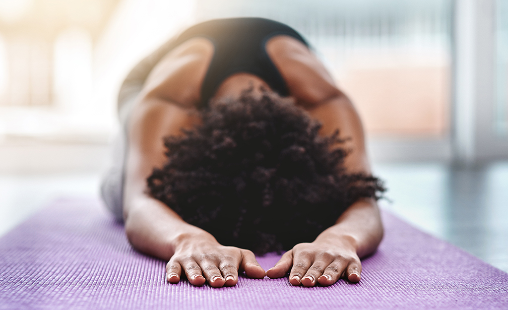 woman lying on yoga mat