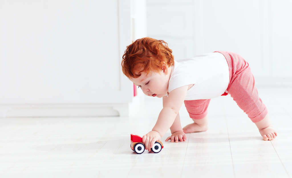 baby playing with toy car