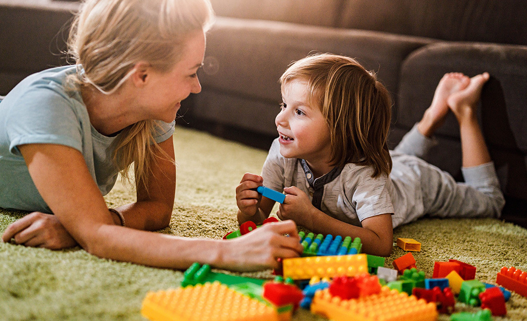 toddler reading with parent